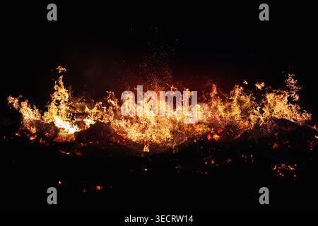 Halloween Witch . Fire embers particles over black background. Fire sparks background. Abstract dark glitter fire particles lights. Stock Photo