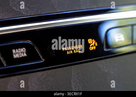 Closeup of car dashboard showing illuminated passenger air bag warning indicator and icon, highlighting vehicle safety system status and modern automo Stock Photo