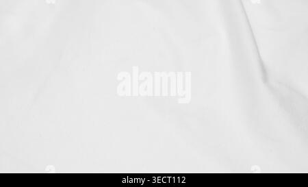 shot showing the subtle texture and soft folds of a white fabric surface. Stock Photo