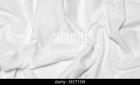 detailed view of white fabric with deep, irregular folds and a soft, matte texture Stock Photo