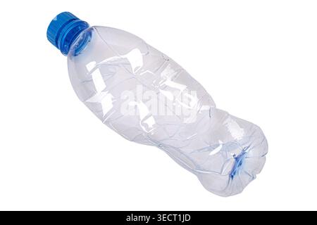 Crumpled plastic bottle with a blue cap on a white background, symbolizing ecological waste Stock Photo