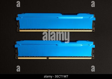 Two blue ram modules laying on a black background, representing computer hardware upgrade Stock Photo