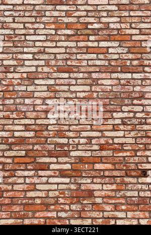 Weathered red brick wall forming a textured architectural background Stock Photo