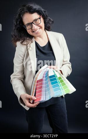 Woman holding color swatch inspiring design ideas Stock Photo