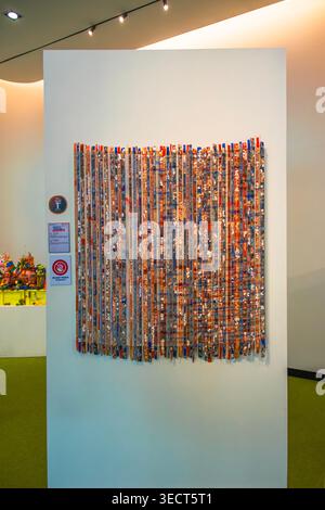 A multi-colored recycled textile mosaic art wall piece displayed at the Trash to Treasure exhibition contest inside the QSNCC venue in Bangkok. Stock Photo