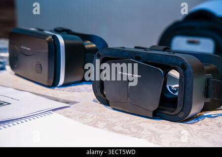 A VR Shinecon smartphone virtual reality headset on a presentation table at a technology trade show booth inside the QSNCC venue hall in Bangkok. Stock Photo
