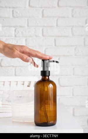 Recycled plastic pump bottle for mock-up. Minimalism brand packaging mockup on white brick wall background Stock Photo