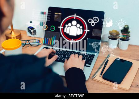 AI audience targeting concept. Person works on laptop with customer icon, charts, data dashboard, and analytics interface for digital marketing, segme Stock Photo