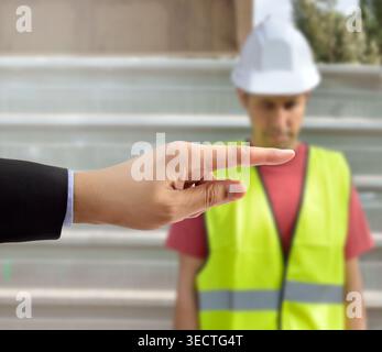 many hands pointing the bullying a workman that is suffering  mobbing on concept of accusation guilty shy,and in concept of dismissal from work Stock Photo
