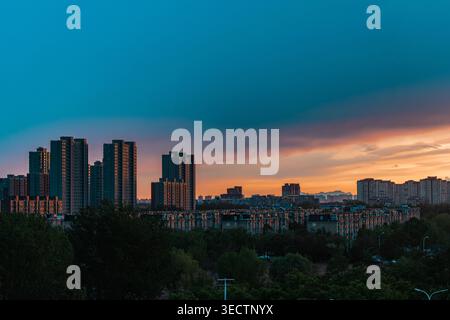 Beijing, China - May 02 2026: Dramatic sunset sky over city skyline and residential high-rise buildings Stock Photo