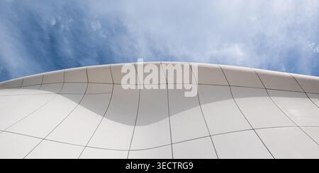 Abstract white curved architecture with smooth geometric patterns and blue sky copy space Stock Photo