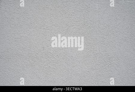 Close up of a white painted textured plaster wall surface with fine hair like texture, crevasses, nooks, crannies, and indentations throughout Stock Photo
