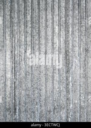 Close up of weathered corrugated tin siding with light and medium gray galvanized texture, mineral deposits, and visible screw heads Stock Photo