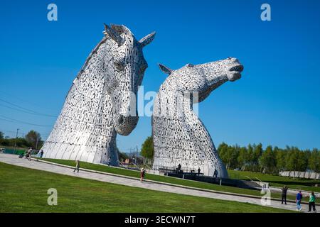 The Kelpies in Falkirk, Scotland, under sunny blue skies. The iconic horse head sculptures are a major Scottish landmark by artist Andy Scott Stock Photo