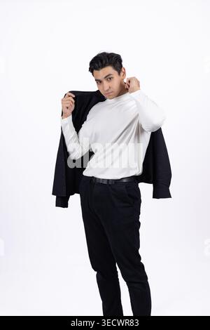 Young man taking off or putting on a black jacket in studio Stock Photo