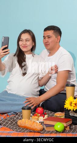 Young couple taking a selfie with a smartphone at picnic Stock Photo