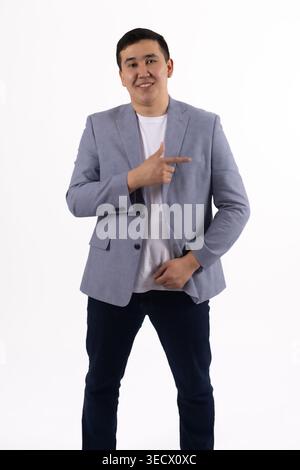 Young man in a blue jacket pointing his finger aside Stock Photo