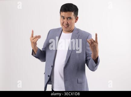 Young man in a blue jacket pointing at himself with thumbs Stock Photo