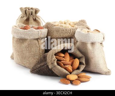 Different types of nuts in burlap bags isolated on white Stock Photo