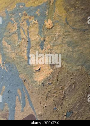 Many layers of peeling paint on an old wall before a new renovation Stock Photo