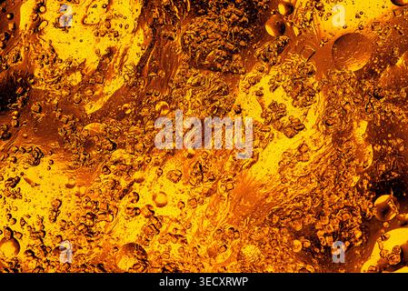 Luxurious flowing golden liquid with shimmering metallic texture and elegant light reflections for premium design projects. Stock Photo