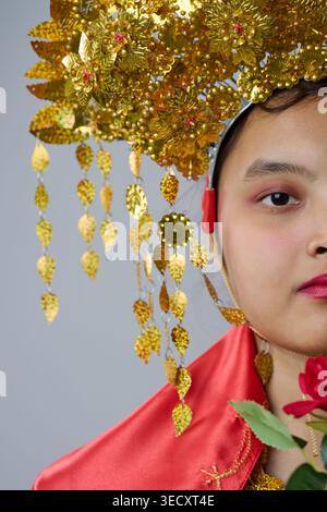 Traditional Gold Headdress Portrait Of A Indonesian Asian Woman In Ornate Ceremonial Costume With Red Silk And Rose Stock Photo