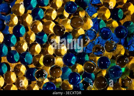 Abstract background with a pattern of blue and gold shapes resembling a mosaic tile or reptile skin texture. Stock Photo