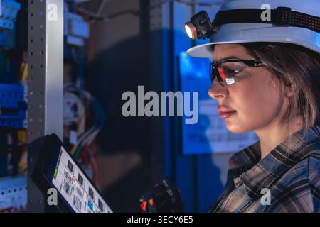 Electrical engineer analyzing power system diagram on tablet. Technical inspection. Stock Photo