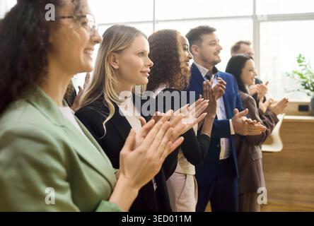 Side view of diverse business professionals applauding during office seminar Stock Photo