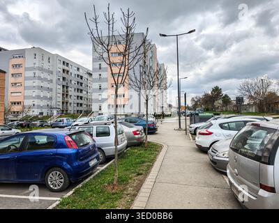 Urban Residential Parking Lot Under Cloudy Sky Stock Photo