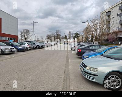Urban Parking Lot Under Cloudy Spring Sky Stock Photo