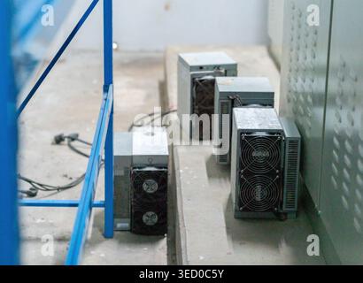 Close-up of specialized industrial electronic power units and cooling systems situated in a warehouse or technical facility. Stock Photo