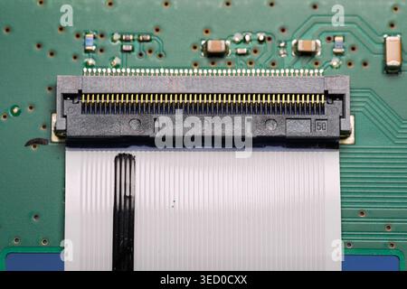 Close up view of a ribbon cable connected to a PCB in an electronic device Stock Photo