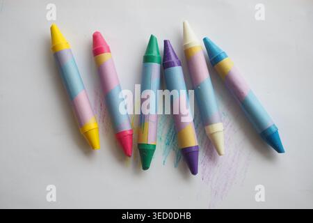 Colorful crayons arranged on a white surface for drawing Stock Photo