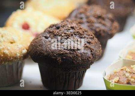 Freshly baked muffins in a bakery display case Stock Photo