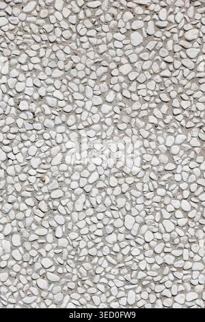 pebbledash roughcast wall background with white pebbles set in cement Stock Photo