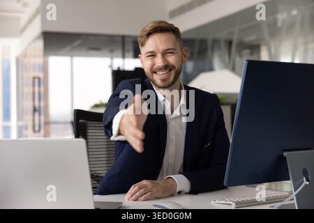 Portrait of businessman extending his hand in welcoming handshake gesture Stock Photo
