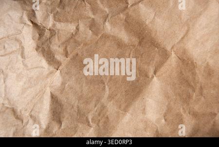 Crumpled brown paper. Brown wrapping paper background. Stock Photo