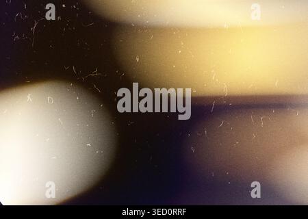 Abstract warm light flares creating vintage overlay texture with dust and grain Stock Photo