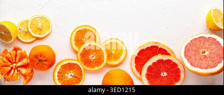 Assorted fresh citrus fruits on white background.Oranges, grapefruits, lemons,tangerines. Clean eating, healthy life. Top view. Stock Photo
