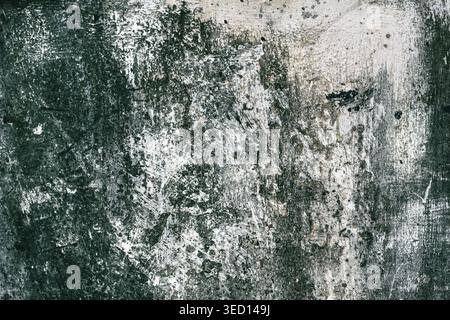 Grunge style urban weathered shabby  peeled painted concrete dark moody surface of the wall with holes, dirty and cracks macro Stock Photo