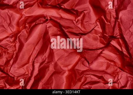 Red very crumbled paper or fabric texture effect from real photo Stock Photo