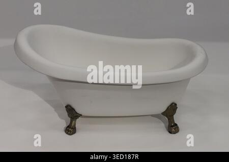 Simple design highlights classic bathroom elegance. Chrome feet contrast softly against smooth porcelain Stock Photo