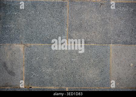 Grey granite stone tile texture background, outdoor floor paving block pattern. Stock Photo