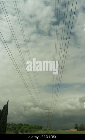 High-voltage power lines run through the orchards of Valencia, Spain. Stock Photo