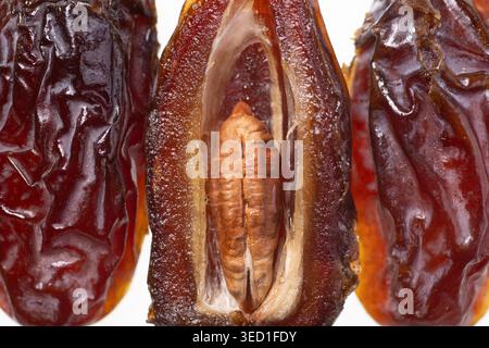 Opened dried dates display seed and textured skin. Stock Photo