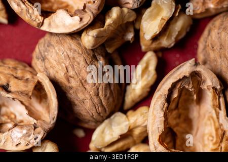 Brown walnut shells and nut pieces are seen up close Stock Photo