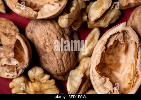 Close view of walnuts in their shells and pieces. Stock Photo