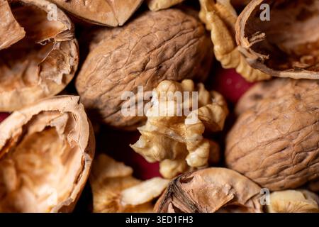 Cracked walnuts and shells on a red background Stock Photo