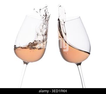 Two glasses clinking filled with rose wine and splash. Stock Photo